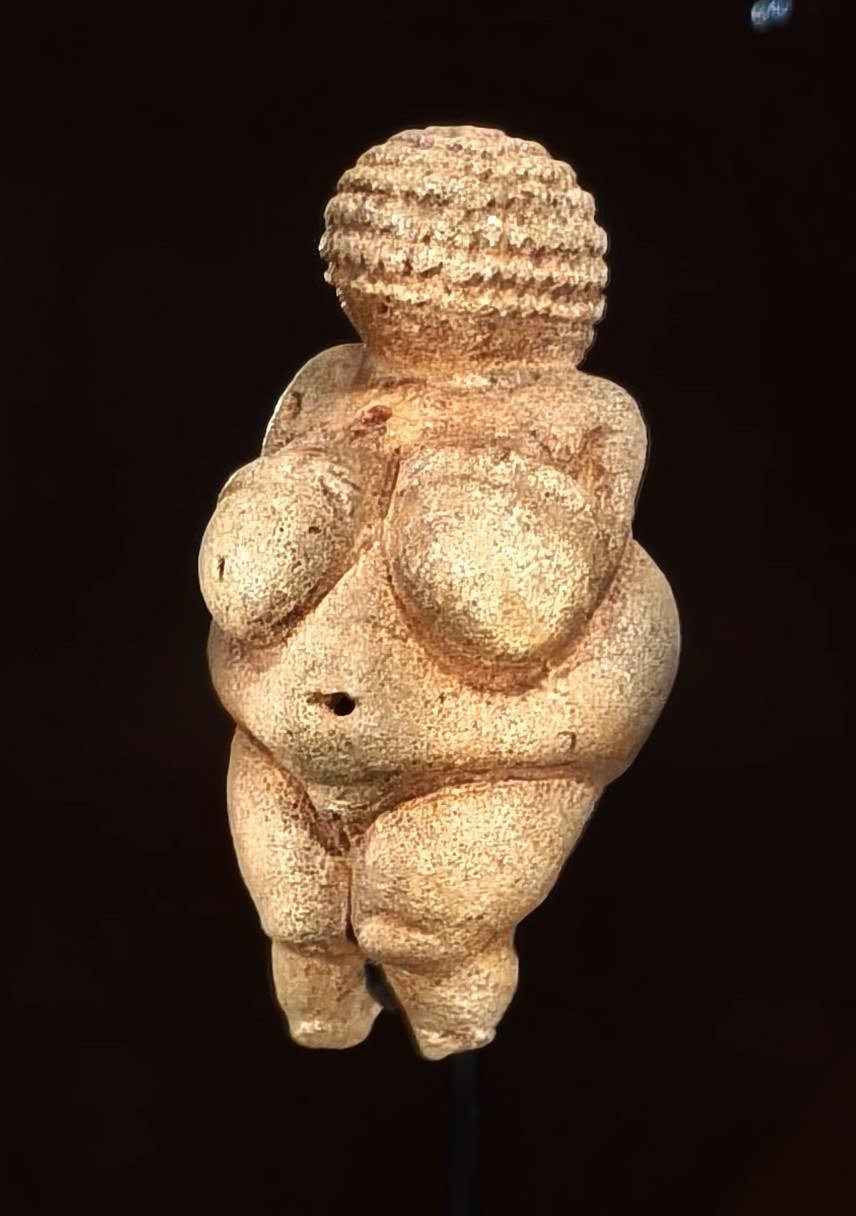 Limestone Venus of Willendorf figurine with an emphasized female body.
