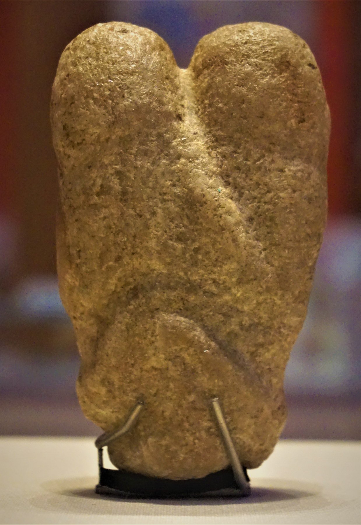 Small calcite sculpture of two intertwined human figures.
